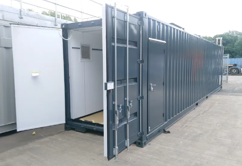Modified shipping container for generator enclosure, featuring insulated interior and personnel access door for secure and weatherproof equipment housing.