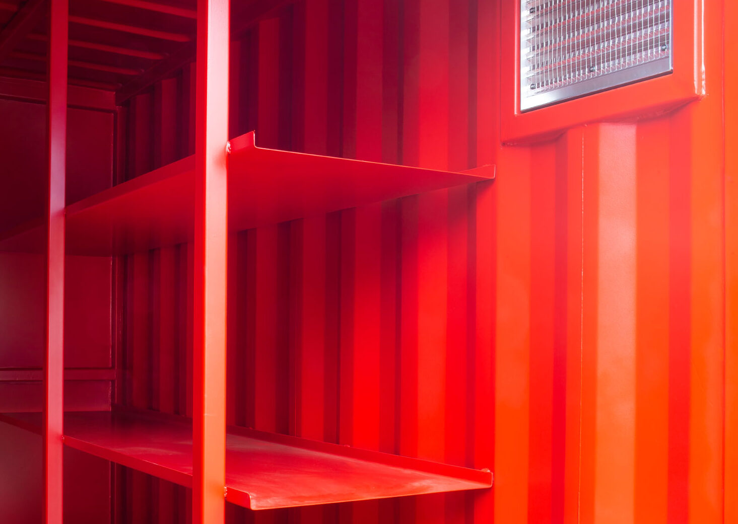 built in shelving in red chemical store container