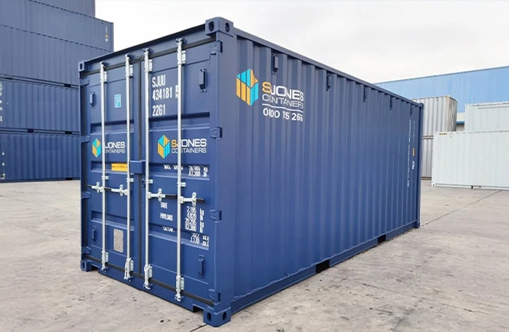 Blue 20ft shipping container photographed at an angle showing the front doors and one corrugated steel side.