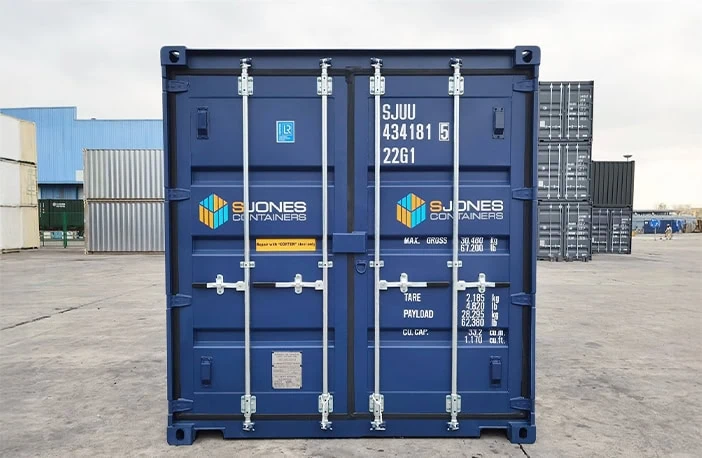 Front of a blue 20ft shipping container with closed double doors, locking bars and S Jones Containers branding
