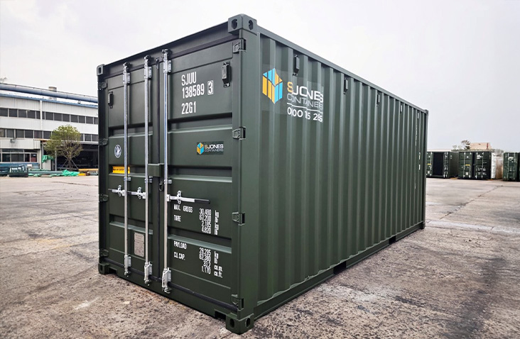Green 20ft shipping container with S Jones Containers branding in an industrial yard, showcasing secure container storage and container sales for commercial and industrial applications in Great Britain.