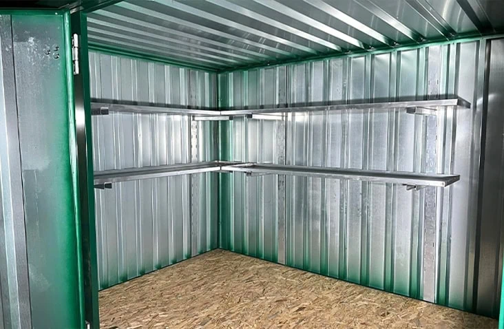     Interior of a flat pack steel storage unit with an optional metal shelf kit installed for organised storage. 