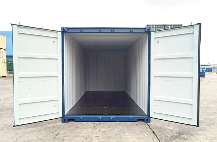 Blue 20ft shipping container with both doors open, showing light grey painted interior and dark plywood flooring. 