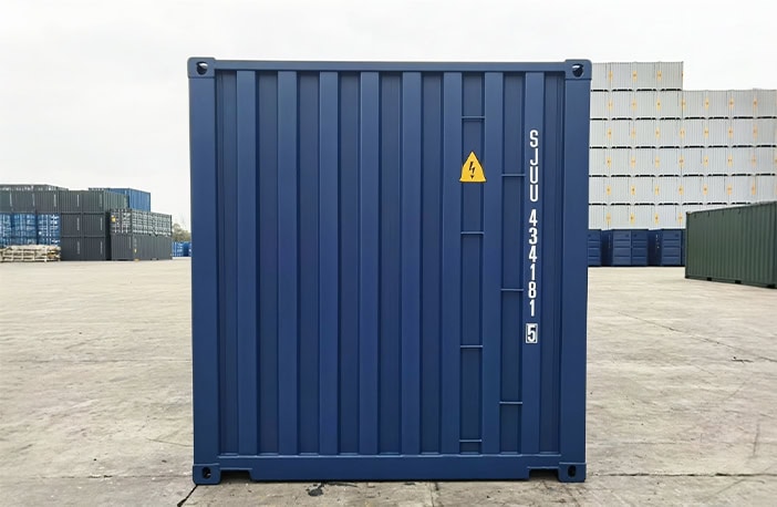 Rear end of a blue 20ft shipping container with solid corrugated steel panel and identification markings.