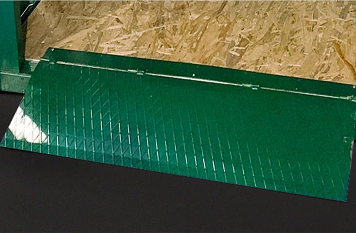 Green metal ramp accessory for flat pack storage units, providing easy access for trolleys and equipment