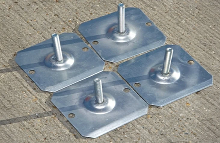Set of galvanised metal levelling feet for flat pack storage units, used to stabilise containers on uneven ground