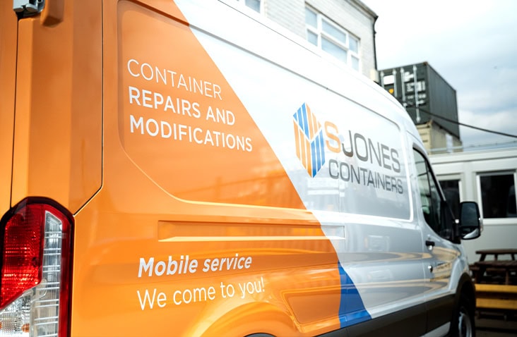 A branded S Jones Containers service van displaying the wording “Container Repairs and Modifications” and “Mobile service – We come to you!”, parked outdoors at a customer site.