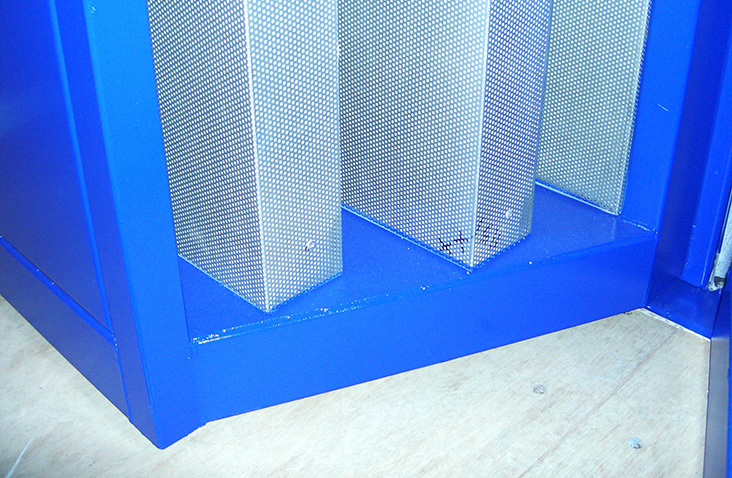 Interior of a converted shipping container with insulated wall panels, surface-mounted electrical conduit, and lighting, designed for housing specialised equipment.