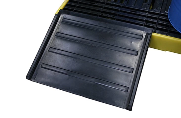 Black heavy-duty plastic container ramp in use on a raised platform, providing a smooth incline for moving equipment onto a grated industrial surface. 