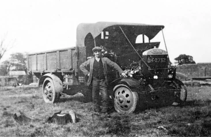 Samuel "Sammy" Jones standing next to his first motor lorry.