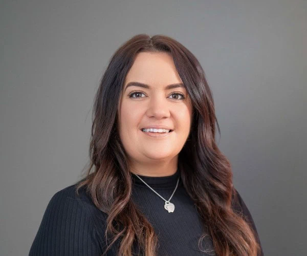 Laura Armitt, Business Development Manager at S Jones Containers, smiling in a professional headshot against a grey background.
