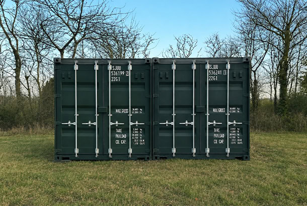 Two green 20ft SJUU (S Jones Containers) shipping containers positioned on a rural farm, providing secure, weather-resistant storage for agricultural equipment, machinery, tools and feed, while also offering an ideal foundation for future container conversions such as farm offices, welfare facilities, workshops or other on-site accommodation.